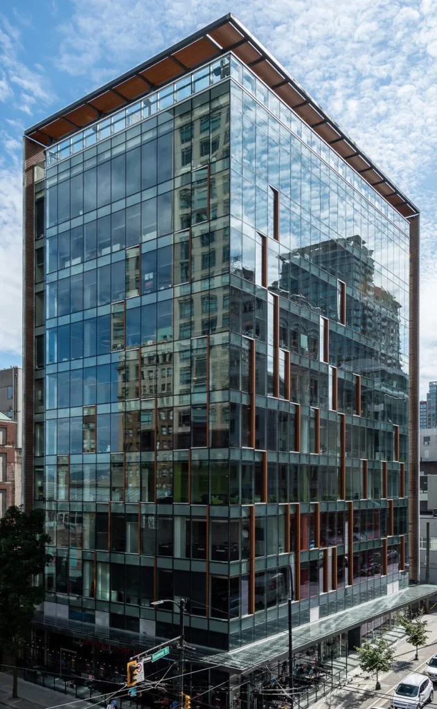 Multi-storey glass curtain wall commercial office building on urban street corner